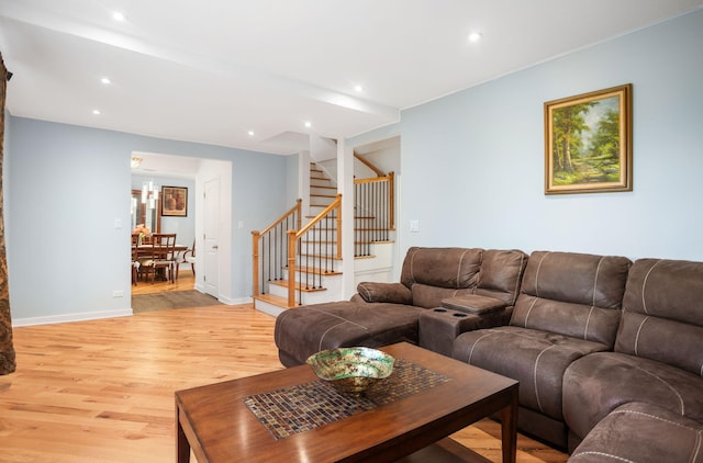 living area with stairway, baseboards, light wood-type flooring, and recessed lighting