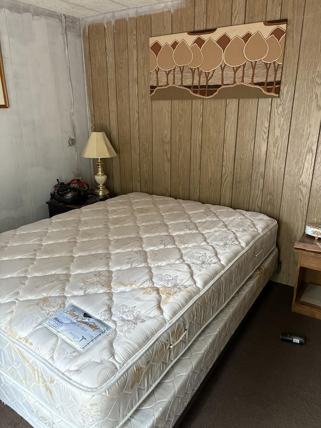 bedroom with wooden walls