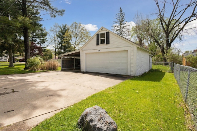 garage featuring fence, a garage, and concrete driveway