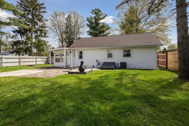 back of property featuring a lawn, a patio area, and a fenced backyard