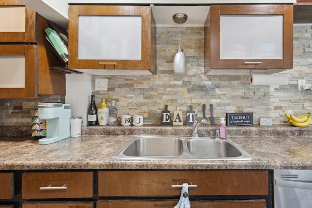 kitchen with a sink, tasteful backsplash, and brown cabinets