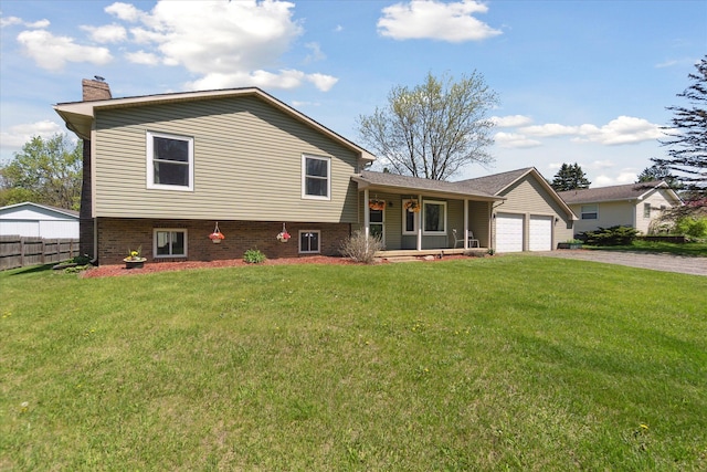 12441 Ray Rd, Ortonville, MI 48462 - split level home featuring covered porch, a chimney, driveway, and a garage