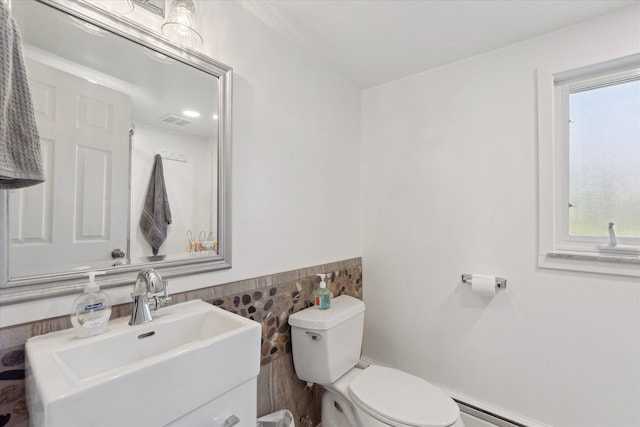 12441 Ray Rd, Ortonville, MI 48462 - bathroom with tile walls, toilet, healthy amount of natural light, vanity, and a wainscoted wall