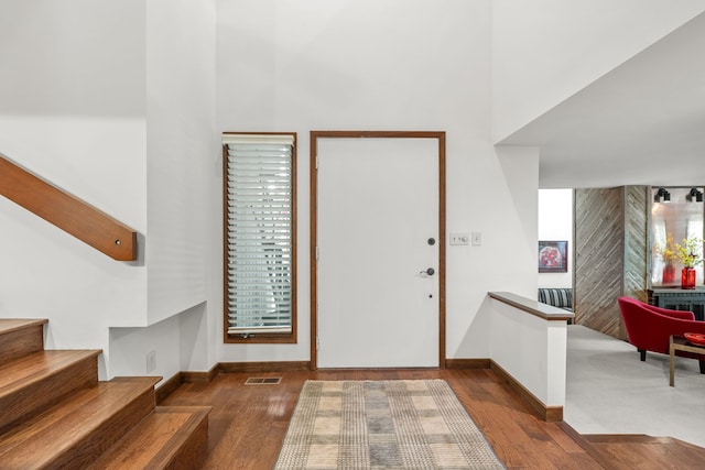 4943 Canyon Oaks Dr, Brighton, MI 48114 - entryway with baseboards, wood finished floors, a towering ceiling, and stairway