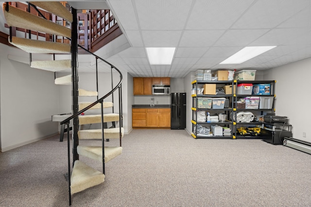 4943 Canyon Oaks Dr, Brighton, MI 48114 - finished below grade area featuring freestanding refrigerator, stairs, light colored carpet, a drop ceiling, and baseboards