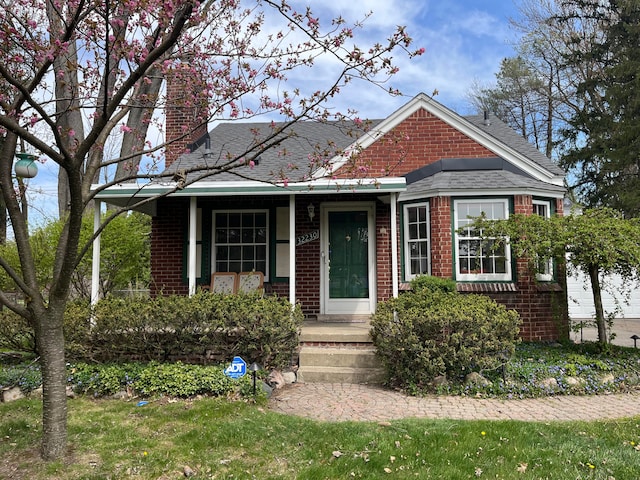 32230 5 Mile Rd, Livonia, MI 48154 - view of front of house with roof with shingles, a chimney, and brick siding