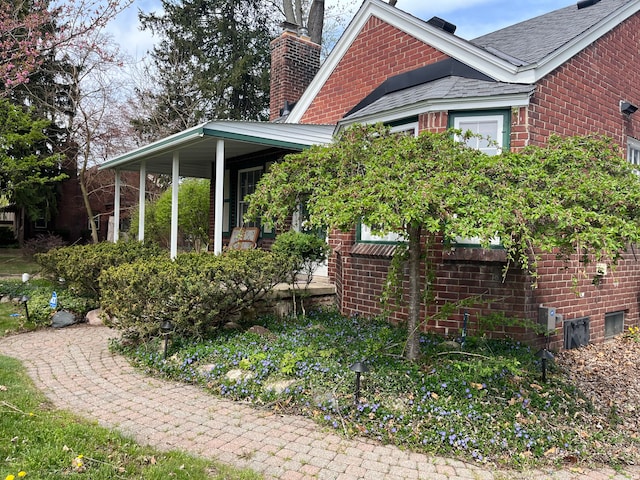 32230 5 Mile Rd, Livonia, MI 48154 - view of property exterior featuring a chimney, roof with shingles, and brick siding