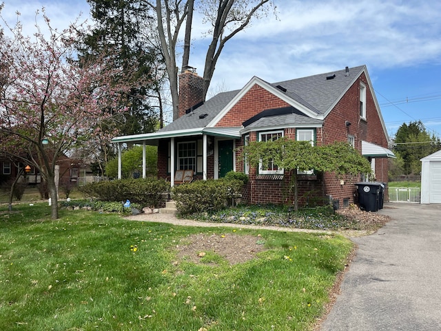 32230 5 Mile Rd, Livonia, MI 48154 - view of front facade with a chimney, brick siding, a porch, roof with shingles, and a front lawn