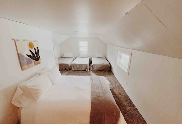 carpeted bedroom featuring lofted ceiling