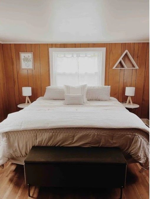 bedroom with wooden walls and wood finished floors