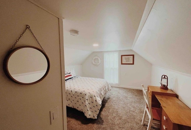 bedroom featuring lofted ceiling and carpet