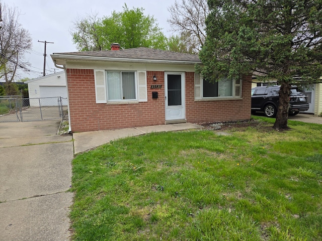 view of front of property featuring a chimney, brick siding, fence, a garage, and a front lawn