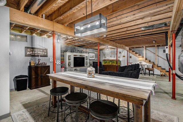 dining room with stairway and concrete flooring