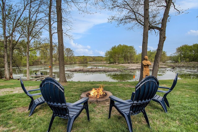 view of yard with a water view and a fire pit