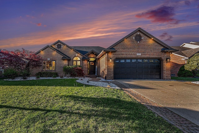16511 Trailway Dr, Macomb, MI 48042 - french country home with driveway, an attached garage, brick siding, and a lawn