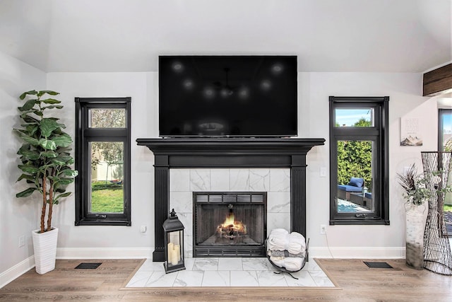 16511 Trailway Dr, Macomb, MI 48042 - detailed view of a tile fireplace, baseboards, and wood finished floors