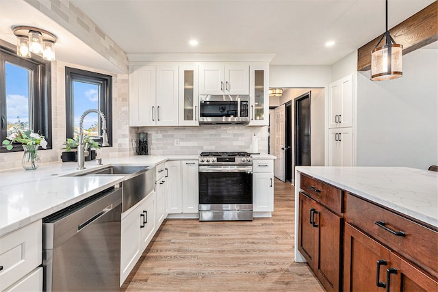 16511 Trailway Dr, Macomb, MI 48042 - kitchen featuring stainless steel appliances, light wood-style floors, white cabinetry, light stone counters, and recessed lighting