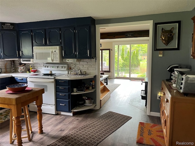 4564 Wildwood Rd, Alger, MI 48610 - kitchen featuring white appliances, light countertops, light wood-type flooring, and a textured ceiling