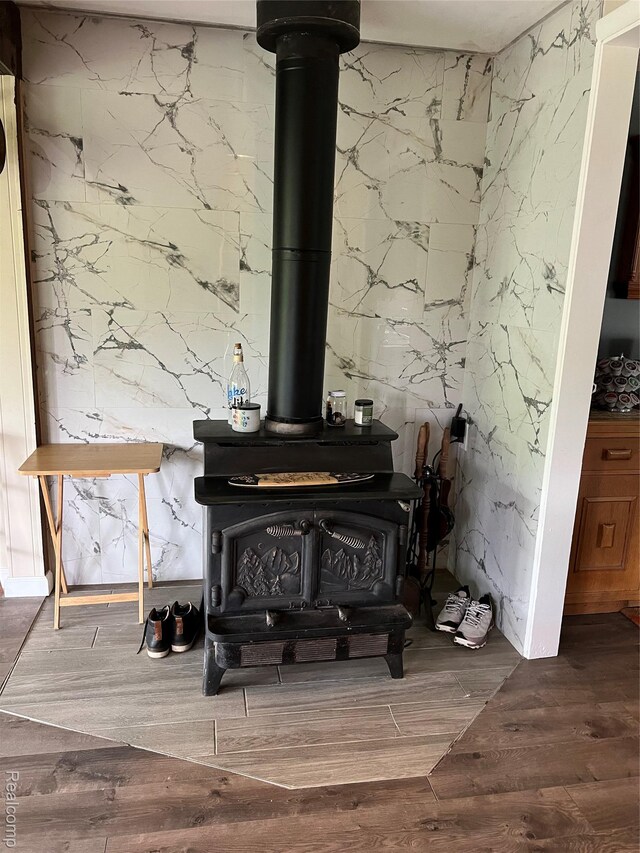 4564 Wildwood Rd, Alger, MI 48610 - detailed view of a wood stove and wood finished floors