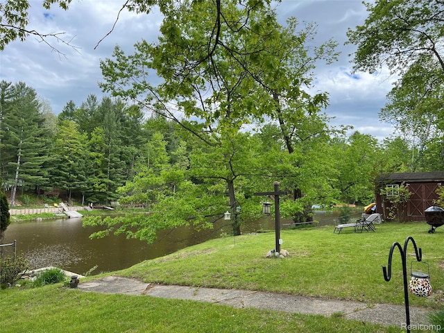 4564 Wildwood Rd, Alger, MI 48610 - view of grassy yard featuring an outdoor structure and a water view