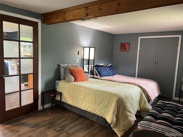 4564 Wildwood Rd, Alger, MI 48610 - bedroom featuring dark wood finished floors and a textured ceiling
