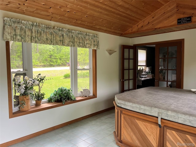 4564 Wildwood Rd, Alger, MI 48610 - dining space featuring lofted ceiling, wood ceiling, baseboards, and light tile patterned flooring