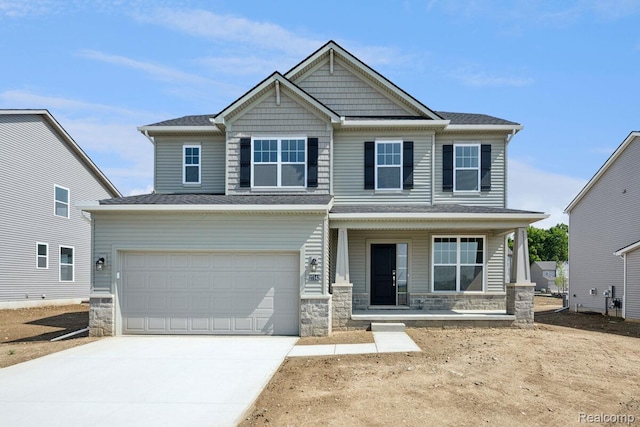 27142 Silo Dr, Saline, MI 48176 - craftsman-style home featuring covered porch, stone siding, concrete driveway, and a garage