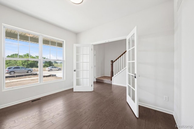 27142 Silo Dr, Saline, MI 48176 - unfurnished room featuring french doors, wood finished floors, and stairway