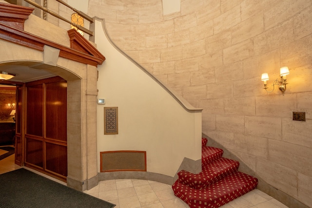 8162 E Jefferson Ave Unit 16A, Detroit, MI 48214 - stairs with arched walkways and tile patterned floors