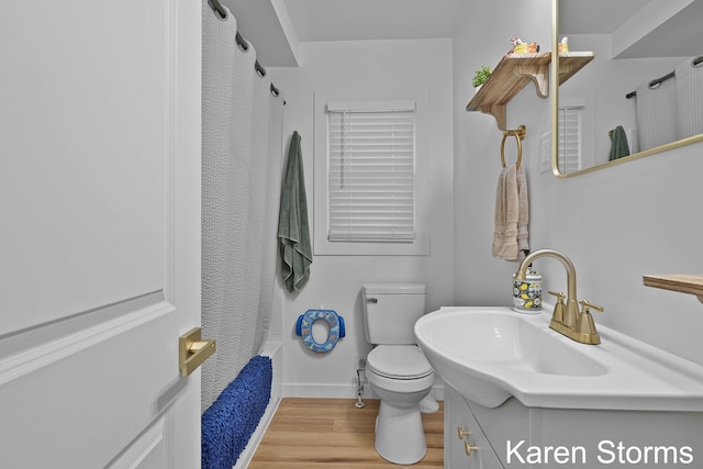 full bathroom with a shower with curtain, toilet, baseboards, vanity, and wood finished floors