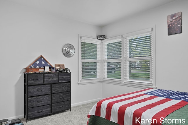 carpeted bedroom featuring baseboards
