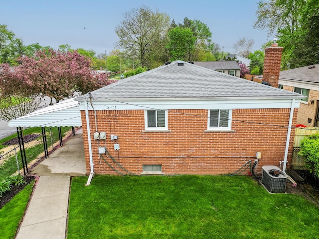18377 Sunset St, Livonia, MI 48152 - back of property with roof with shingles, brick siding, and central AC unit