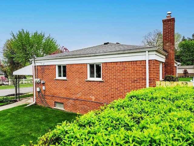 18377 Sunset St, Livonia, MI 48152 - view of side of home featuring a chimney, brick siding, and roof with shingles