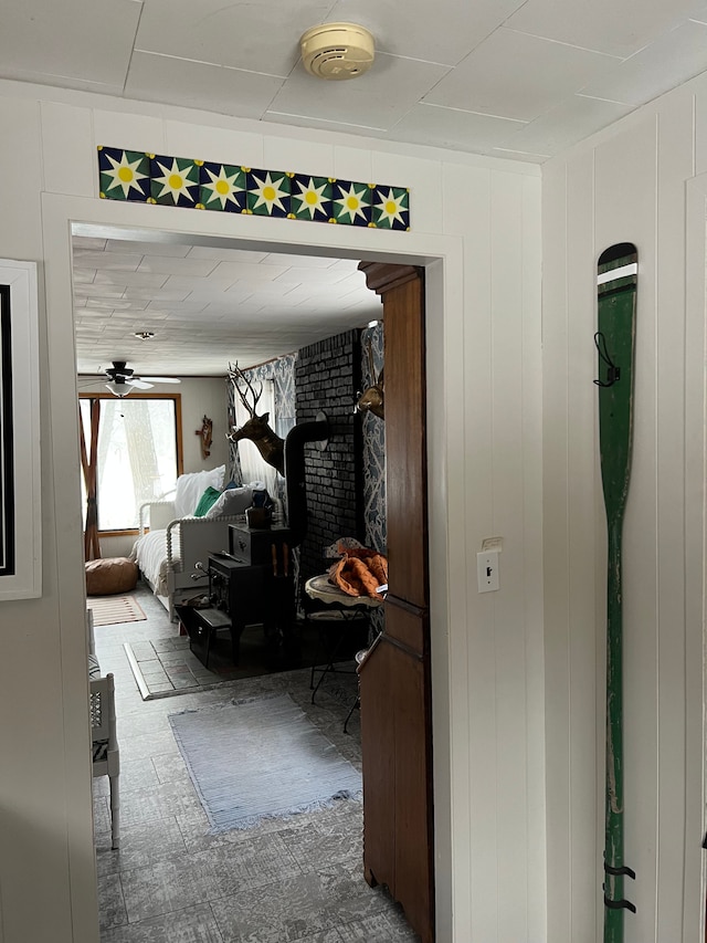 hall with tile patterned floors