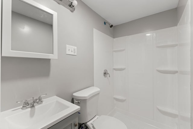 full bathroom with walk in shower, toilet, and vanity