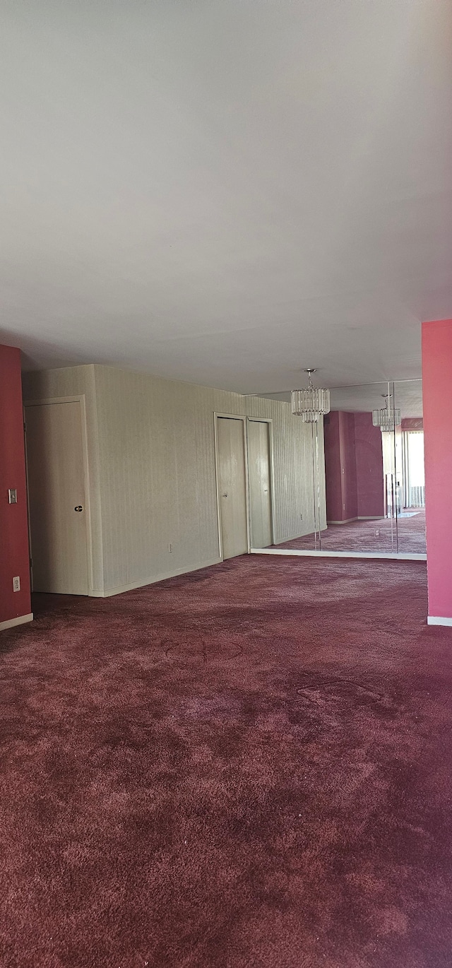 6660 Maple Lakes Dr, West Bloomfield, MI 48322 - spare room with a chandelier and carpet
