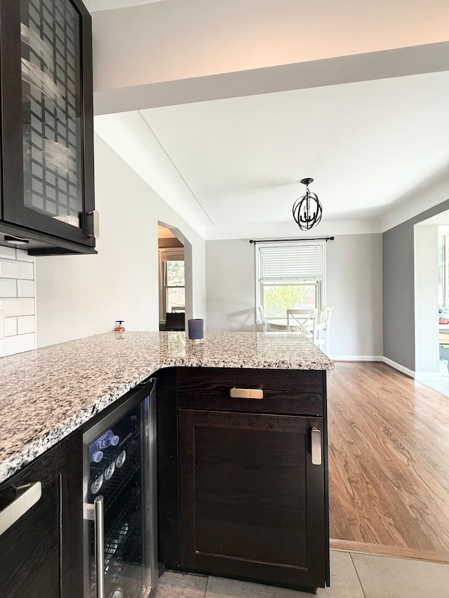 135 S Waverly St, Dearborn, MI 48124 - kitchen with light stone countertops, wine cooler, a peninsula, and plenty of natural light