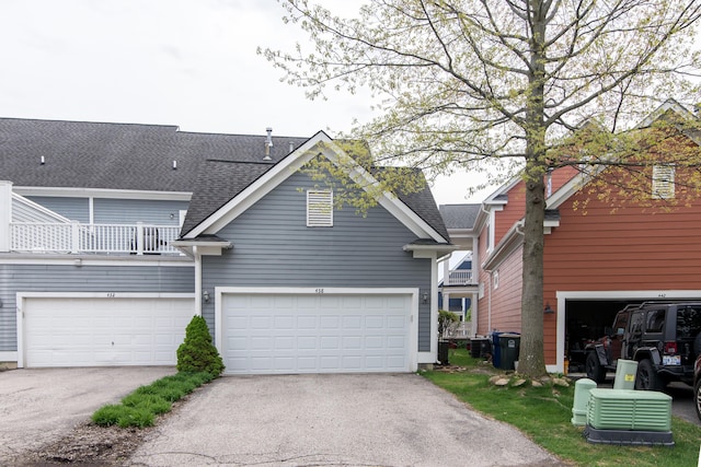 438 Filmore St, Canton, MI 48188 - view of front facade featuring a balcony, a garage, a shingled roof, and driveway