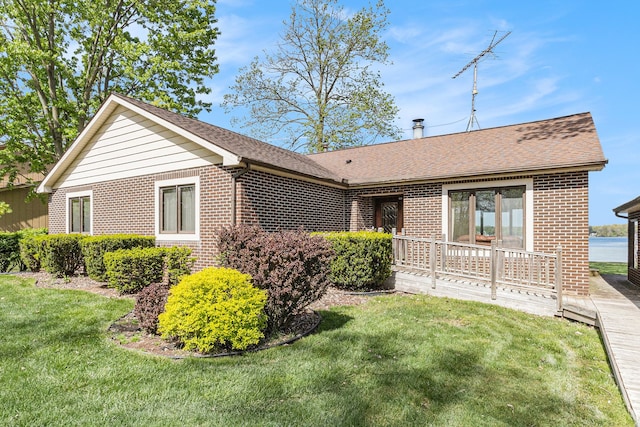 8570 Riverside Dr, Brighton, MI 48116 - ranch-style home with brick siding, a front yard, and a shingled roof