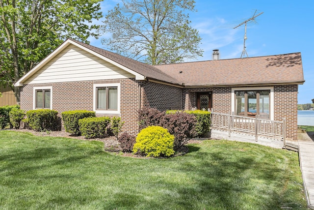 8570 Riverside Dr, Brighton, MI 48116 - single story home with brick siding, a front lawn, and roof with shingles