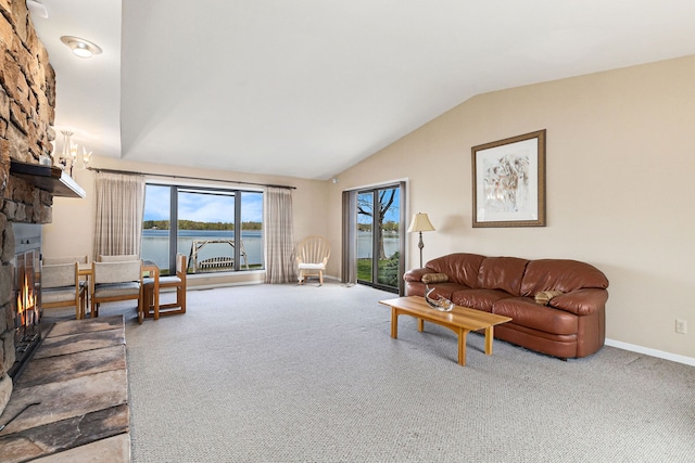 8570 Riverside Dr, Brighton, MI 48116 - living area with carpet flooring, a fireplace, a water view, vaulted ceiling, and baseboards