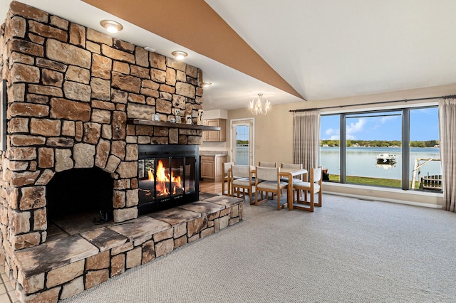 8570 Riverside Dr, Brighton, MI 48116 - living area with carpet floors, a stone fireplace, vaulted ceiling, a chandelier, and a water view