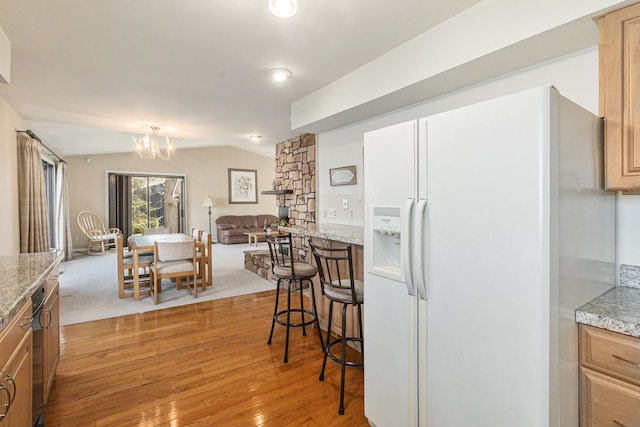 8570 Riverside Dr, Brighton, MI 48116 - kitchen featuring white fridge with ice dispenser, a chandelier, vaulted ceiling, light wood-style flooring, and open floor plan