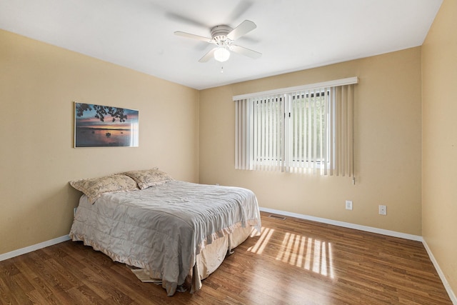 8570 Riverside Dr, Brighton, MI 48116 - bedroom with baseboards, wood finished floors, and ceiling fan