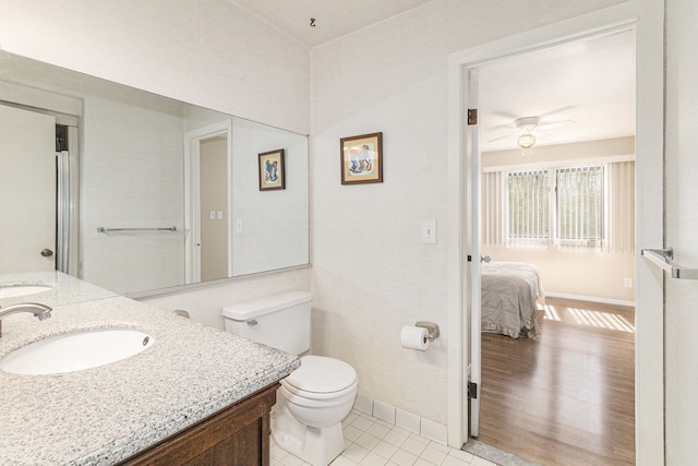 8570 Riverside Dr, Brighton, MI 48116 - bathroom featuring ceiling fan, toilet, baseboards, and vanity
