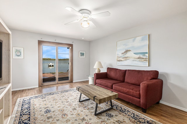 8570 Riverside Dr, Brighton, MI 48116 - living room with wood finished floors, ceiling fan, and baseboards