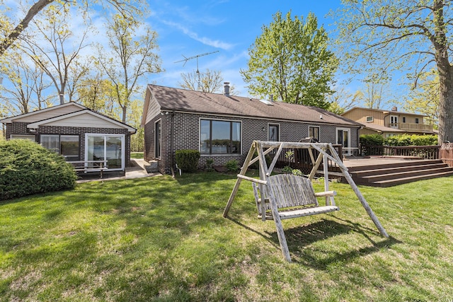 8570 Riverside Dr, Brighton, MI 48116 - rear view of property with a deck, brick siding, a chimney, and a yard