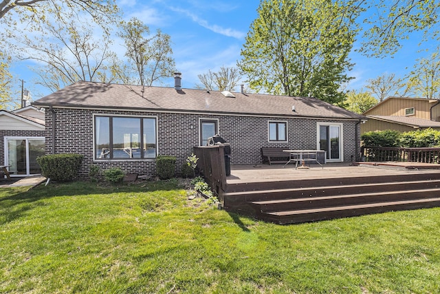 8570 Riverside Dr, Brighton, MI 48116 - rear view of house with brick siding, a deck, a yard, and a shingled roof