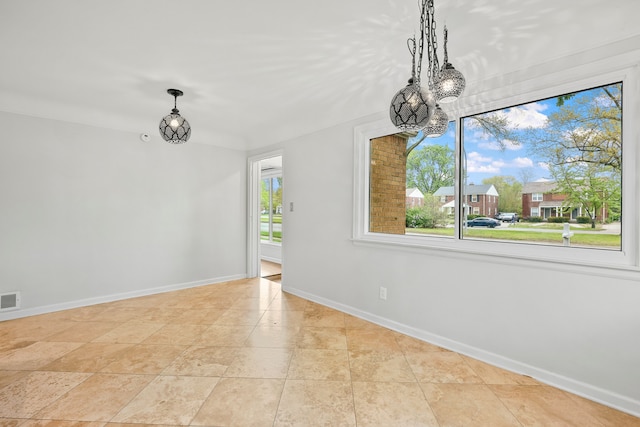 unfurnished dining area featuring baseboards, a notable chandelier, and visible vents