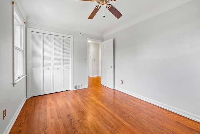 unfurnished bedroom featuring light wood finished floors, baseboards, and visible vents